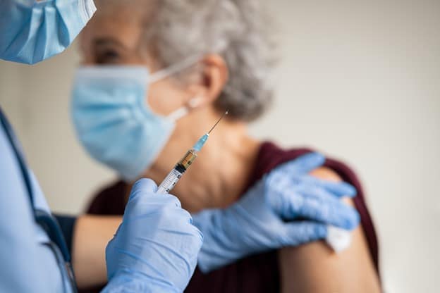 elderly woman getting a vaccine