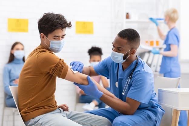 young man getting the COVID-19 vaccine